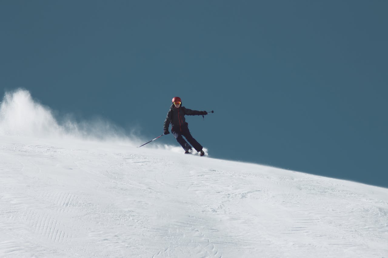 about-04 Thrilling shot of a skier carving through snow in Sölden, Austria on a bright winter day.