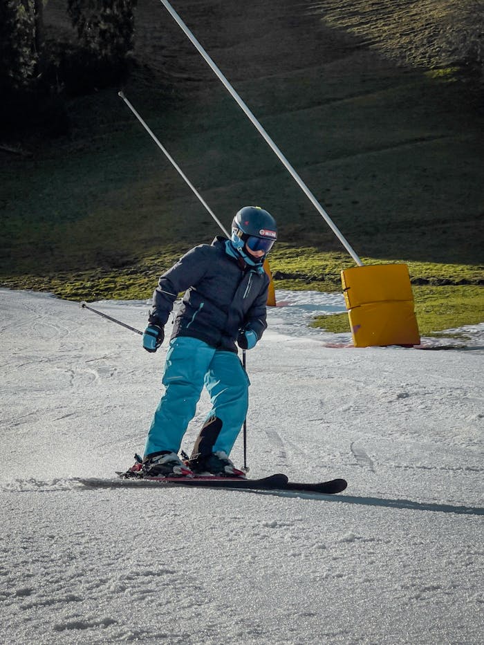 services-03 A skier in winter gear enjoying a sunny day on the ski slope.